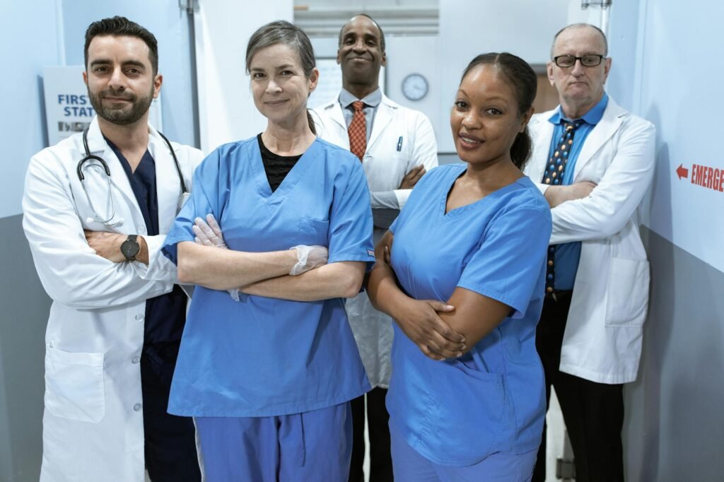 For Clinics & Professionals A diverse team of doctors and nurses smiling confidently in a hospital setting.